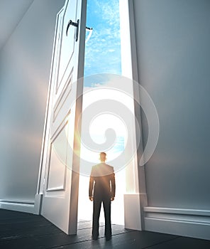 Businessman walking in open door