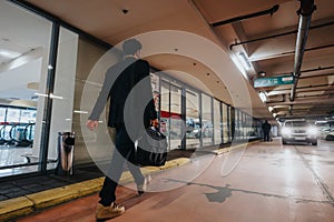 Businessman walking in parking garage heading to work