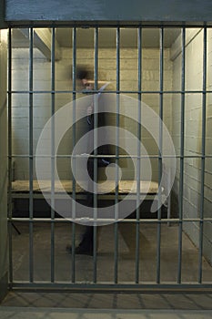 Businessman Walking In Prison Cell