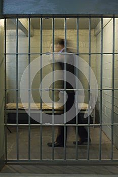 Businessman Walking In Prison Cell