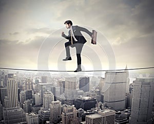 Businessman walking on a rope