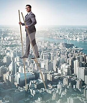 Businessman walking on stilts - standing out from the crowd