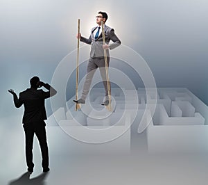 Businessman walking on stilts - standing out from the crowd