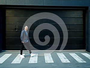 Businessman walking on street to office.