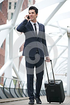Businessman walking and talking on the phone at metro station