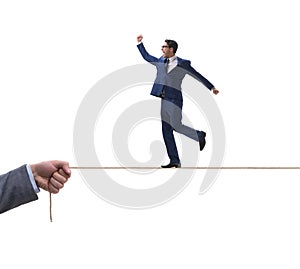 Businessman walking on tight rope