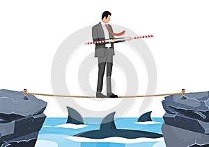 Businessman walking a tightrope over shark in sea