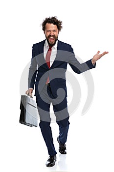 Businessman walking towards the camera with an open arm