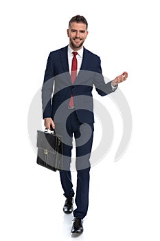 Businessman walking towards the camera with an open arm