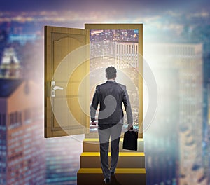 Businessman walking towards open door