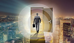 The businessman walking towards open door