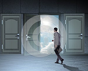 Businessman walking towards open door