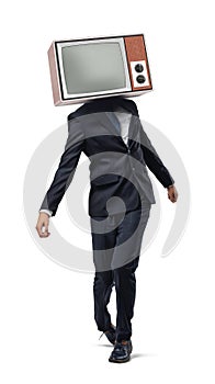 A businessman walking unsteady on his legs and wearing a retro TV instead of his head.