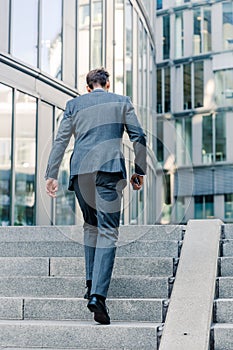 Businessman walking upstairs in an office park