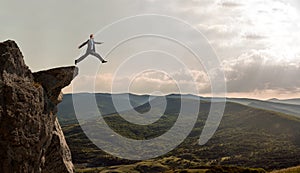 Businessman walks through an abyss