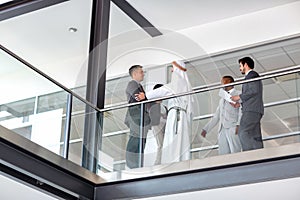 Businessman warmly greet Arabian partner in hall