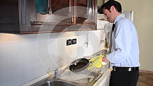 Businessman washing dishes