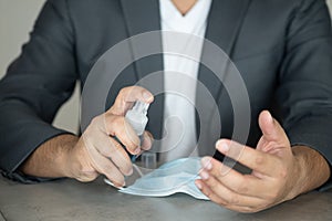 Businessman washing hands with spraying alcohol. Hygiene sanitize concept