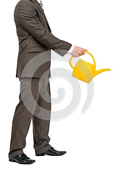 Businessman with watering-can on white