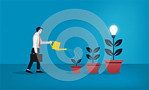 Businessman watering the trees of bulb concept. Growing new idea and creativity symbol