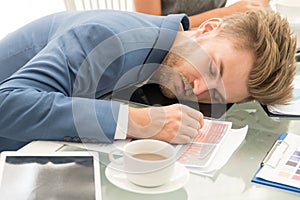 Businessman wear blue suit white coffee sleeping at white office desk breakdown looking tired. Business people working