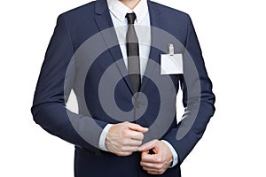Businessman wearing a blank ID tag or name card at an exhibition or conference
