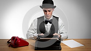 Businessman wearing bowler using typewriter