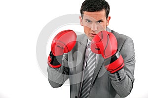Businessman wearing boxing gloves