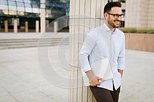 Businessman wearing glasses holding tablet