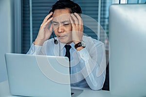 Businessman wearing headset working actively in office