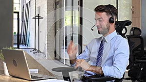 Businessman wearing headset working in office to support remote customer