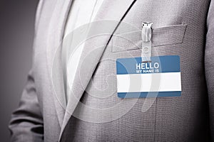 Businessman wearing Hello my name is tag