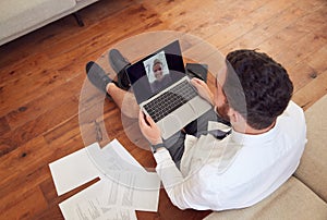 Businessman Wearing Loungewear And Shirt And Tie For Video Call On Laptop Working From Home