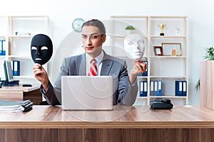 Businessman wearing mask in hypocrisy concept photo