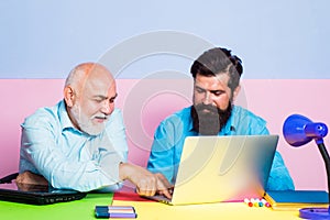 Businessman wearing shirt working with laptop at table. Business men team of two people talk and work together on laptop