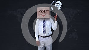 Businessman wearing smiley face box pointing on globe