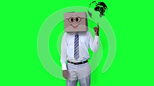 Businessman wearing smiley face box pointing on globe against greenscreen