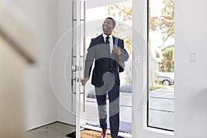 Businessman Wearing Suit Opening Door Returning Home From Work