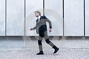 Businessman wearing suit running to work