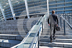 Businessman wearing suit running up the stairs
