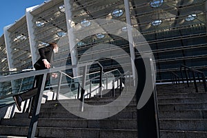 Businessman wearing suit running up the stairs