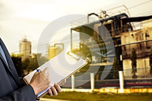 Businessman wearing suit writing on notepad and isolated background