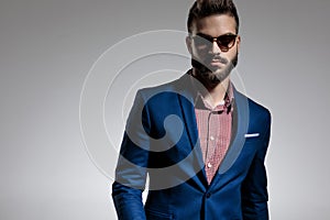 Businessman wearing sunglasses posing with attitude