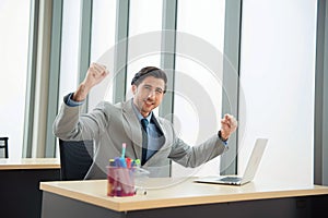 Businessman wearing tie very happy and excited doing winner gesture with arms raised, smiling for success. Celebration concept