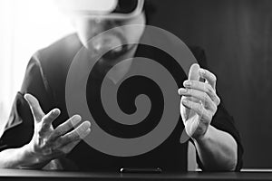 businessman wearing virtual reality goggles in modern office wit