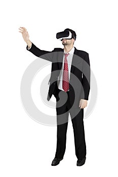 Businessman wearing virtual reality goggles on studio