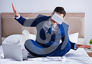 Businessman wearing a virtual reality headset in the bedroom