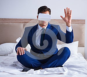 Businessman wearing a virtual reality headset in the bedroom