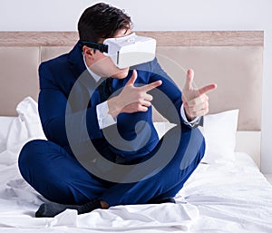 Businessman wearing a virtual reality headset in the bedroom