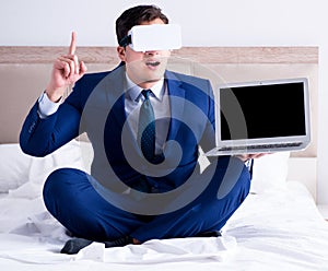 Businessman wearing a virtual reality headset in the bedroom